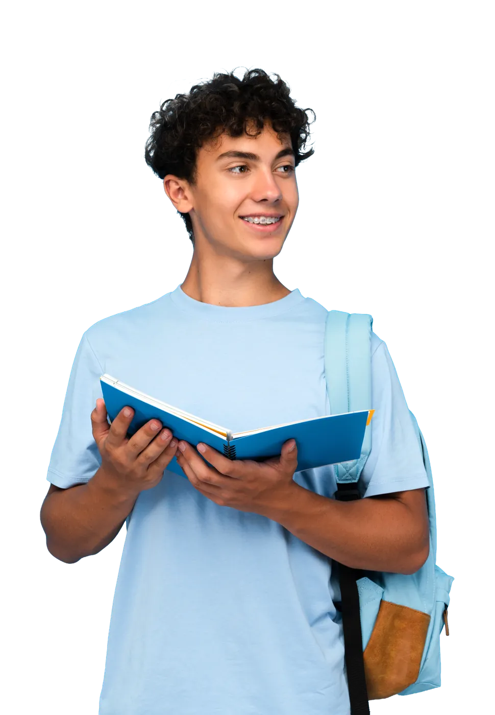 A student smiling while reading an open book