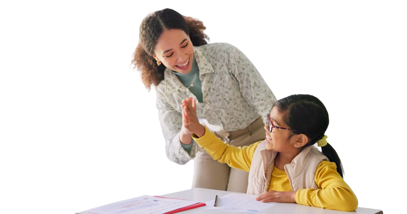 A teacher and a student high-fiving at a desk