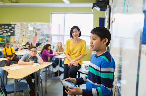 A teacher working with students in a Dallas County classroom